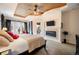 Luxurious main bedroom boasts fireplace, decorative ceiling, and access to the backyard at 2117 S Juniper St, Lakewood, CO 80228