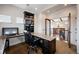 Office with granite countertops and built-in bookshelves with a view of the living room at 2117 S Juniper St, Lakewood, CO 80228