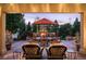 Inviting outdoor patio with a fireplace, dining table, and scenic backyard views at 2117 S Juniper St, Lakewood, CO 80228