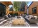 Cozy backyard patio with a fire pit, comfortable seating, and lush greenery, ideal for outdoor relaxation at 619 S High St, Denver, CO 80209