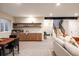 Basement featuring a bar with shelving, a staircase, and a comfortable seating area at 619 S High St, Denver, CO 80209