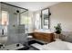 Luxurious bathroom features a glass-enclosed shower, modern vanity, and soaking tub at 619 S High St, Denver, CO 80209