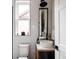 Modern bathroom features a vessel sink, subway tile walls, black accents, and a stylish mirror at 619 S High St, Denver, CO 80209