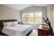 Bright bedroom featuring a comfortable bed, a stylish side table, and a large window with natural light at 619 S High St, Denver, CO 80209