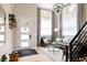 Bright foyer with hardwood floors, modern chandelier, and staircase leading to the second floor at 619 S High St, Denver, CO 80209