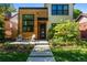 Attractive home with a modern exterior, a well-kept lawn, and a charming front porch with seating at 619 S High St, Denver, CO 80209