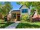 Beautiful two-story home with modern design, well-maintained landscaping, and a cozy front porch seating area at 619 S High St, Denver, CO 80209