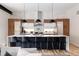 Bright, modern kitchen featuring a large island with seating, custom cabinetry, and stylish pendant lighting at 619 S High St, Denver, CO 80209