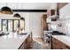 Gourmet kitchen featuring sleek cabinets, stainless steel appliances, a large island and modern lighting at 619 S High St, Denver, CO 80209