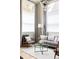 Sunlit living room featuring modern lighting fixture, neutral-colored furnishings, and large windows with curtains at 619 S High St, Denver, CO 80209