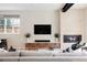 Cozy living room featuring a modern fireplace, a large television, and comfortable seating at 619 S High St, Denver, CO 80209