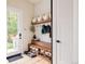 Well-organized mudroom featuring a bench with shoe storage, hooks, and shelves for added convenience at 619 S High St, Denver, CO 80209