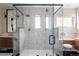 Bright glass shower features a tiled bench, overhead rain shower head, and contemporary fixtures at 619 S High St, Denver, CO 80209