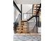 Open staircase showcases wooden treads, black metal railings and beams, and abundant natural light at 619 S High St, Denver, CO 80209