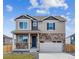 Charming two-story home with stone accents, a covered porch and a two-car garage at 6519 14Th St, Frederick, CO 80530