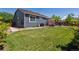 Back yard features a well-maintained lawn, privacy fence, and pergola-covered patio area at 2670 E 136Th Pl, Thornton, CO 80602