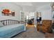 Cozy bedroom transitions to living room through french doors, features art and neutral color palette at 2670 E 136Th Pl, Thornton, CO 80602