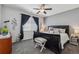 This bedroom has carpet, a ceiling fan, stylish furniture, black-out curtains, and an updated look at 2670 E 136Th Pl, Thornton, CO 80602
