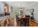 Bright dining area featuring hardwood floors, stainless steel appliances, and a sliding door to the backyard at 2670 E 136Th Pl, Thornton, CO 80602