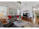 Bright living room featuring hardwood floors, a comfortable sofa, and stylish decor at 2670 E 136Th Pl, Thornton, CO 80602