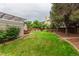 The backyard boasts a lush green lawn, privacy fence, mature trees and a covered patio deck at 8588 S Woody Way, Highlands Ranch, CO 80126