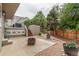 A cozy backyard with a fire pit, covered deck, and beautiful landscaping for outdoor enjoyment at 8588 S Woody Way, Highlands Ranch, CO 80126