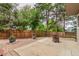 Private backyard featuring a spacious patio, wooden fence, mature trees, and manicured landscaping at 8588 S Woody Way, Highlands Ranch, CO 80126