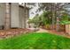Backyard featuring a lush lawn, privacy fence, mature trees and beautiful landscaping at 8588 S Woody Way, Highlands Ranch, CO 80126