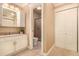Well-lit bathroom with a tiled floor, shower, toilet, and plenty of storage at 8588 S Woody Way, Highlands Ranch, CO 80126
