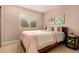 A stylish bedroom featuring a window, a bed with fluffy pillows, and artwork on the wall at 8588 S Woody Way, Highlands Ranch, CO 80126