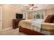 Cozy bedroom featuring a ceiling fan and a large window for natural light at 8588 S Woody Way, Highlands Ranch, CO 80126