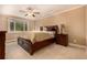 Serene bedroom featuring a king-sized bed, neutral tones, and carpeted floors at 8588 S Woody Way, Highlands Ranch, CO 80126