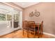 Cozy dining area with wood floors, a sliding glass door to the exterior, and a bicycle decoration at 8588 S Woody Way, Highlands Ranch, CO 80126