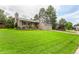 A well-maintained two story home featuring a lush green lawn and mature trees in a suburban setting at 8588 S Woody Way, Highlands Ranch, CO 80126