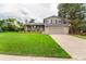 Charming two-story home featuring a brick facade, manicured lawn, and a two-car attached garage at 8588 S Woody Way, Highlands Ranch, CO 80126