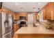 Bright kitchen featuring stainless steel appliances, wooden cabinets, and a functional layout at 8588 S Woody Way, Highlands Ranch, CO 80126
