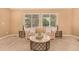 Bright living room featuring neutral paint and carpet, large windows, and stylish furnishings at 8588 S Woody Way, Highlands Ranch, CO 80126