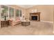 Cozy living room with a fireplace, plush sofa, and natural light streaming through the windows at 8588 S Woody Way, Highlands Ranch, CO 80126