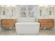 This bright bathroom features double vanities, a freestanding tub, and shuttered windows at 474 W Spruce St, Louisville, CO 80027