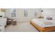 Sunlit bedroom with three windows, plush carpet, and stylish, low-profile bed frame at 474 W Spruce St, Louisville, CO 80027