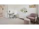 Bright bedroom with an office setup, a modern dresser with round mirror and seating area at 474 W Spruce St, Louisville, CO 80027