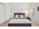 A cozy bedroom features a plush bed, a stylish nightstand, and a window with shuttered blinds at 474 W Spruce St, Louisville, CO 80027