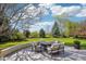 Landscaped backyard featuring a stone fire pit and patio furniture on well manicured lawn at 474 W Spruce St, Louisville, CO 80027