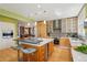 Kitchen featuring stainless appliances, center island, bar seating, and sleek modern cabinets at 474 W Spruce St, Louisville, CO 80027