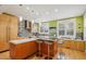Spacious modern kitchen with a center island, bar seating, stainless steel appliances, and hardwood floors at 474 W Spruce St, Louisville, CO 80027