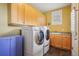 Convenient laundry room with front loading washer and dryer, sink, and built-in storage cabinets at 474 W Spruce St, Louisville, CO 80027