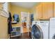 Laundry room features modern washer, hooks for storage, and access to the rest of the home at 474 W Spruce St, Louisville, CO 80027
