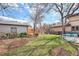 Large backyard features a lawn area, patio, and mature landscaping at 1380 S Fillmore St, Denver, CO 80210