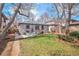 Spacious backyard with a patio, dining table, and lush grassy area under mature trees at 1380 S Fillmore St, Denver, CO 80210