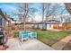 Backyard featuring a patio with a dining table and grill, plus a grassy area at 1380 S Fillmore St, Denver, CO 80210